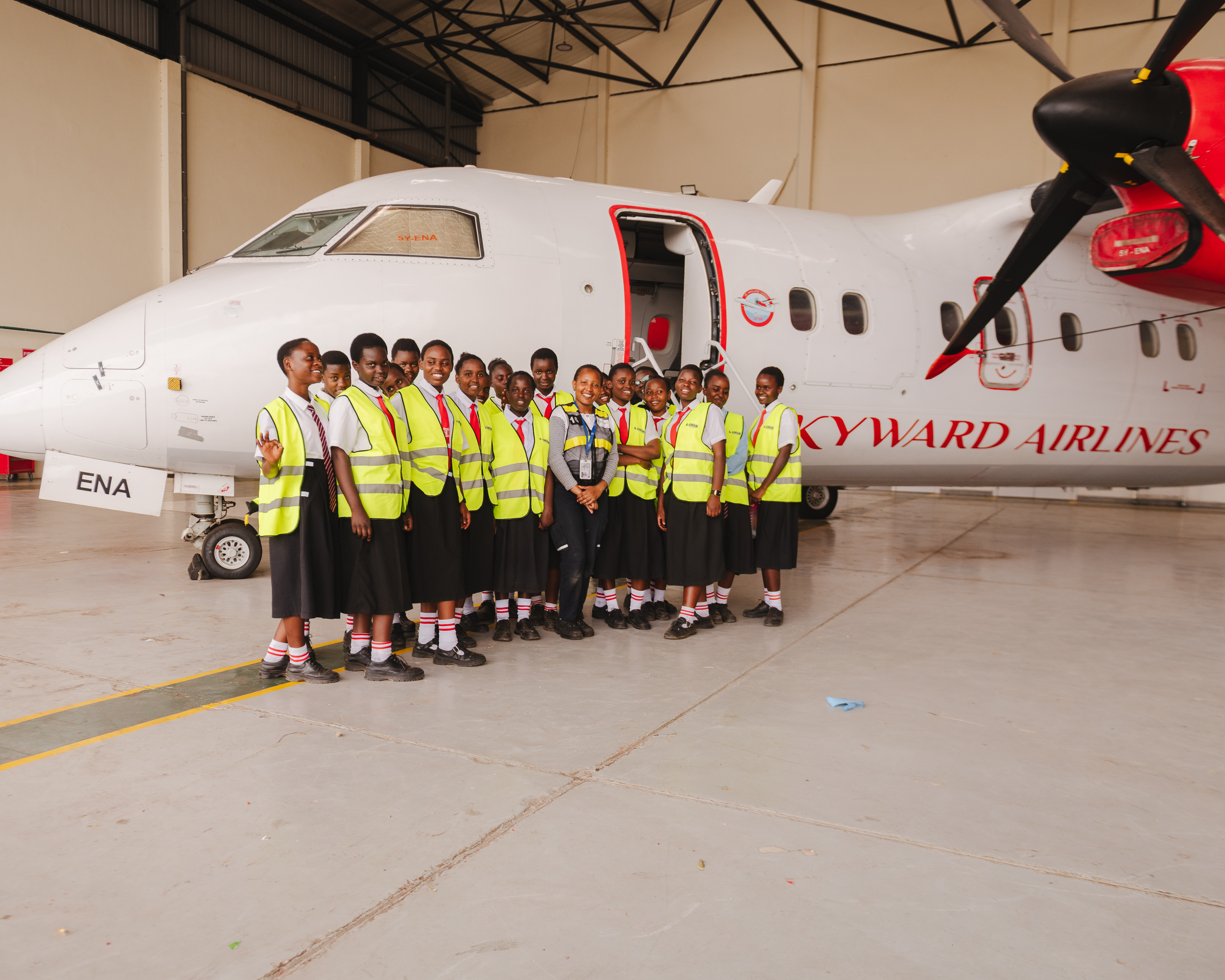 Girls posed in front of plane